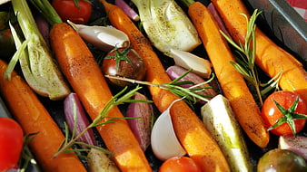 Roasted carrots, endive, and tomatoes on baking tray