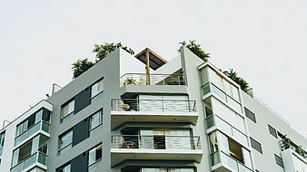 Modern Apartment Building with Balconies and Rooftop Garden