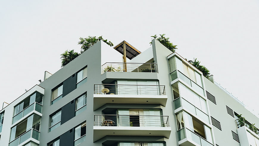 Modern Apartment Building with Balconies and Rooftop Garden