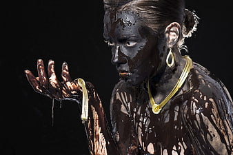 Conceptual Portrait of Woman Covered in Chocolate with Gold Jewelry