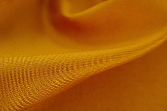 Close-up of textured orange fabric with soft folds