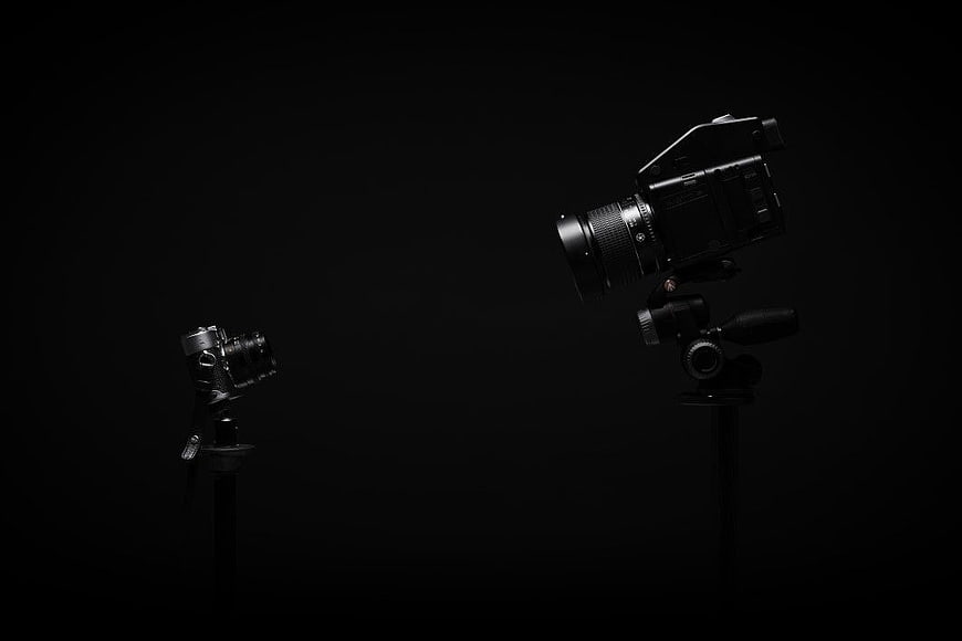 Cinematic Camera and Vintage Camera on Black Background