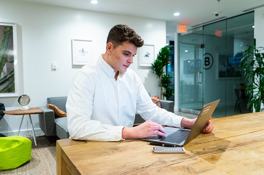 Young man working on laptop in modern office