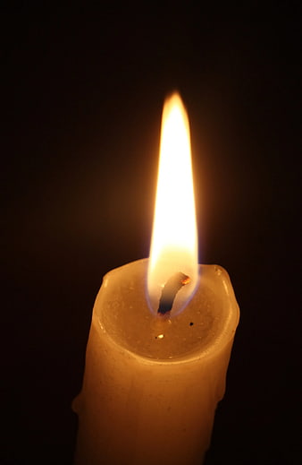 Close-up of a burning candle flame on black background