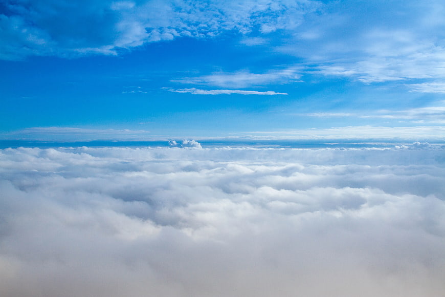 Aerial View of Fluffy White Clouds Under Blue Sky