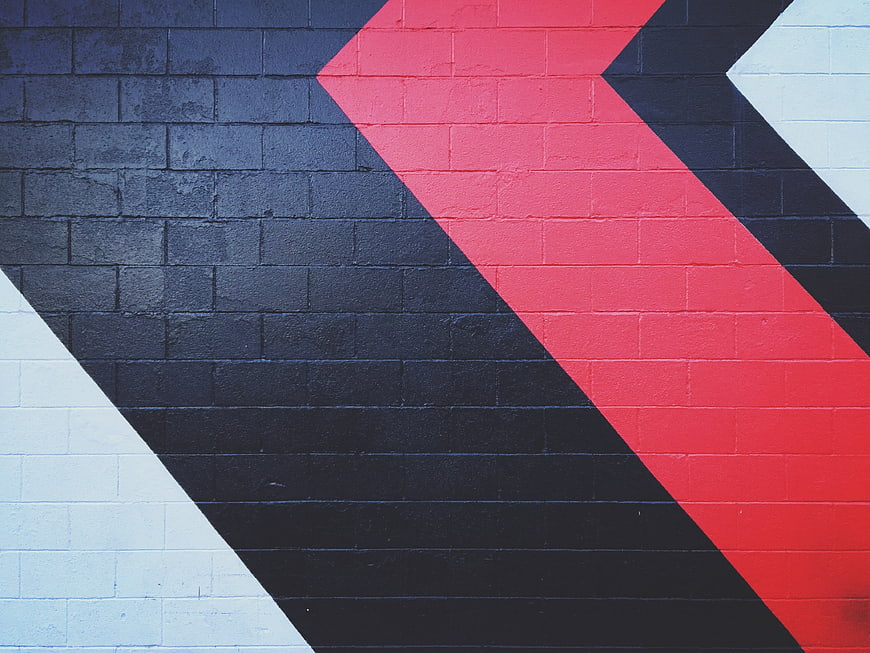 Abstract geometric mural on textured brick wall