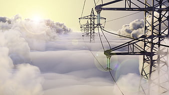 High Voltage Power Lines Above Clouds At Sunrise