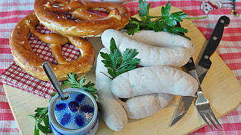 Traditional Bavarian white sausages with pretzels and mustard