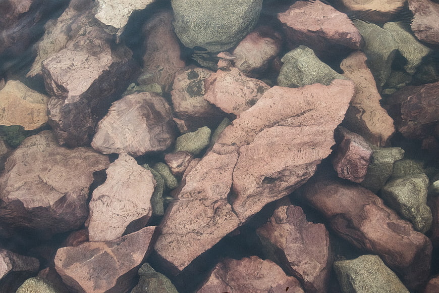 Underwater rocks in clear water with ripples