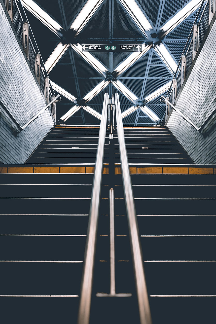 Symmetrical Subway Stairs with Metal Handrails and Neon Lights