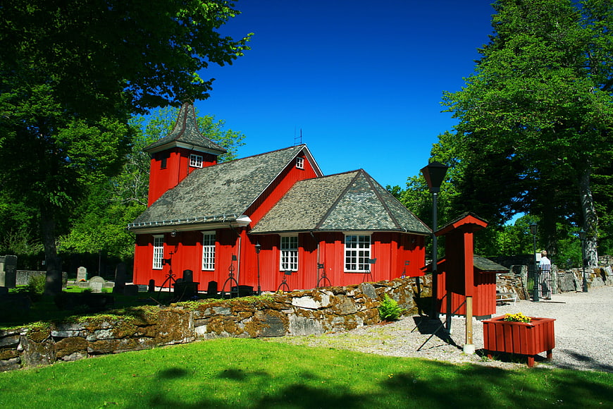 Traditional red wooden church in Swedish landscape