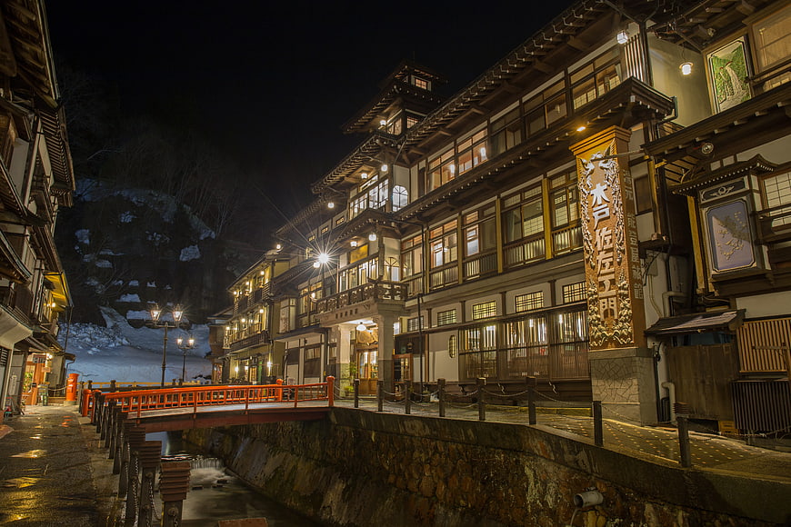 Traditional Japanese Ryokan Street at Night with Snow