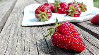 Fresh Red Strawberry on Weathered Wooden Table