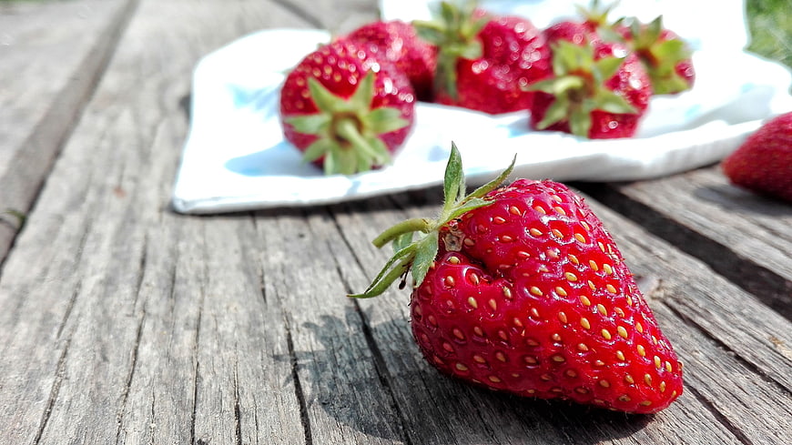 Fresh Red Strawberry on Weathered Wooden Table