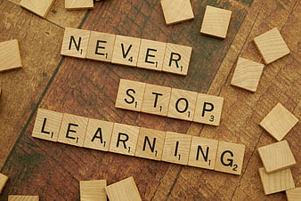Wooden Scrabble Tiles Spelling Never Stop Learning on Wood