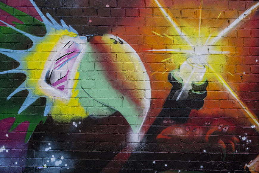Colorful graffiti art on brick wall with spray can