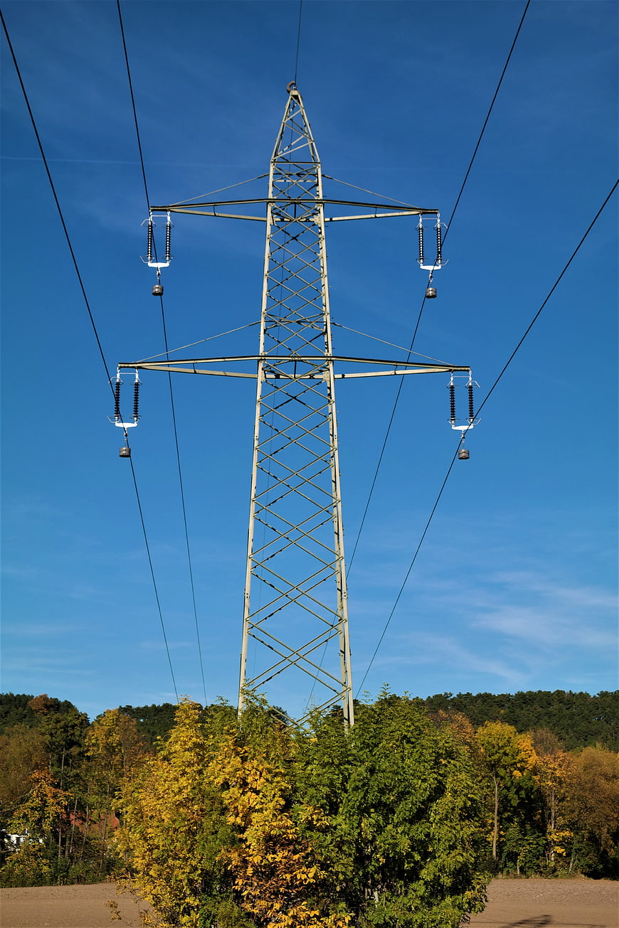 High Voltage Power Line Tower Against Blue Sky