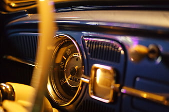 Close-up of vintage blue car dashboard with speedometer