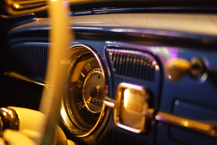 Close-up of vintage blue car dashboard with speedometer