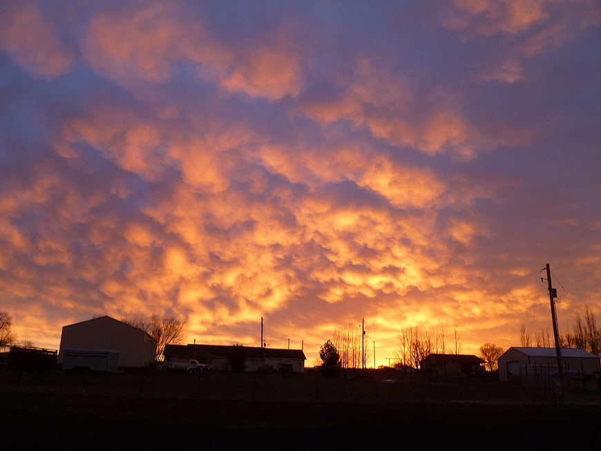 Dramatic Fiery Sunset Sky Over Rural Silhouette