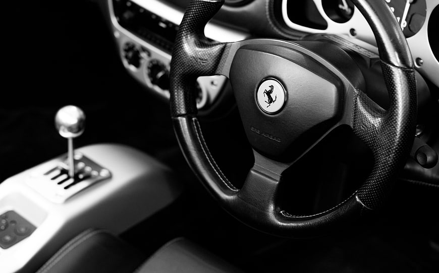 Black and white Ferrari steering wheel and gear shift interior
