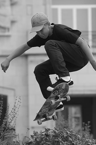 Young Skateboarder Performing Mid-Air Trick in Black and White