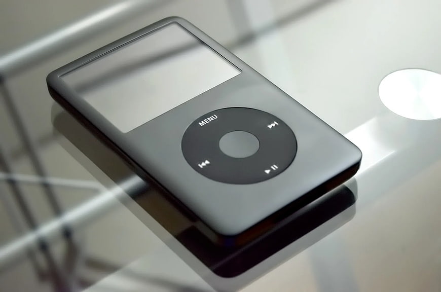 Gray iPod Classic on Reflective Surface