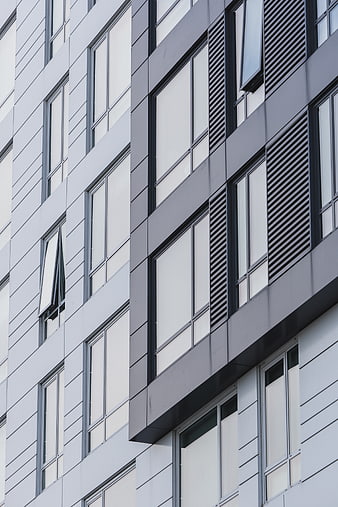 Modern gray building facade with geometric windows