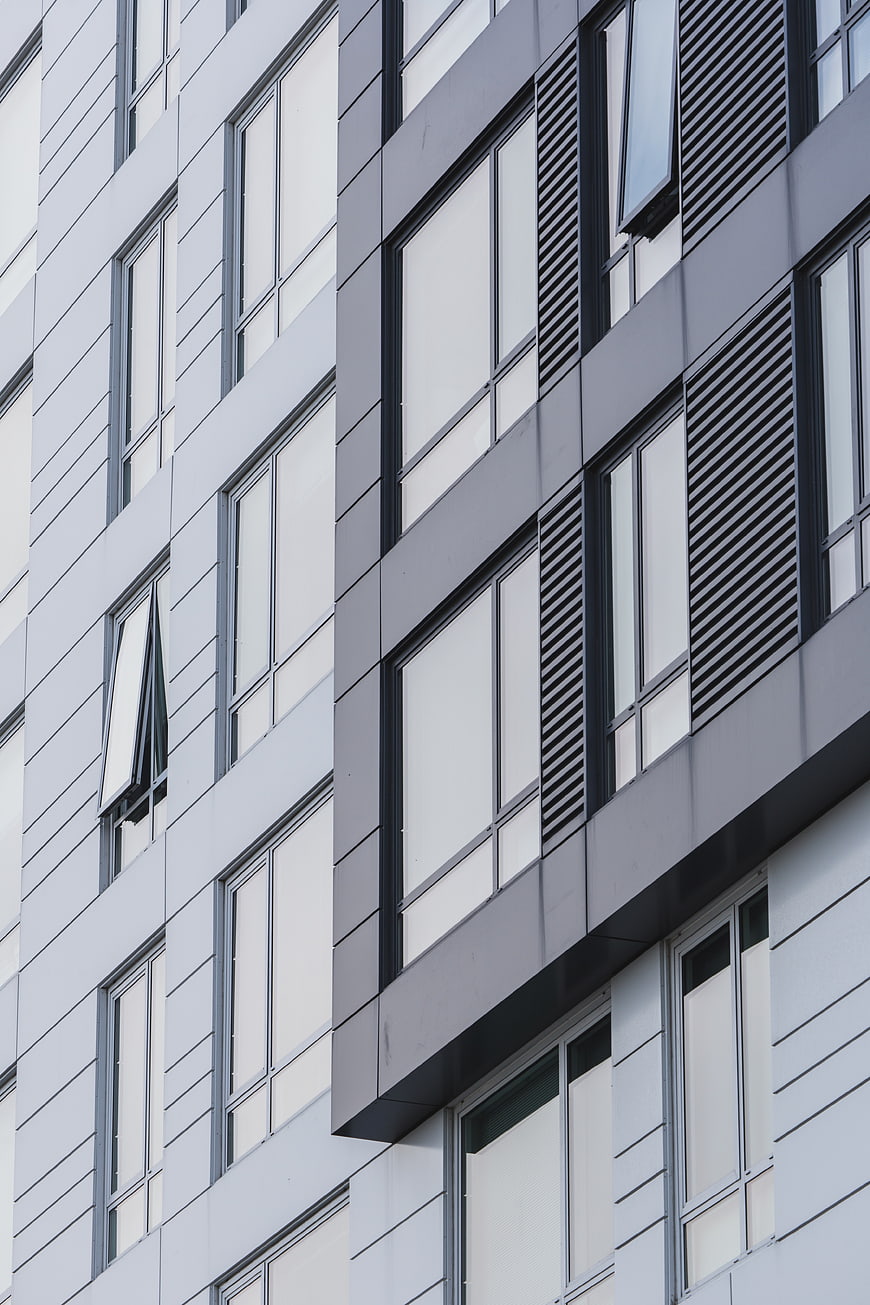 Modern gray building facade with geometric windows