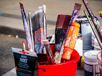 Used Paint Brushes in Red Cup with Acrylic Paint Supplies