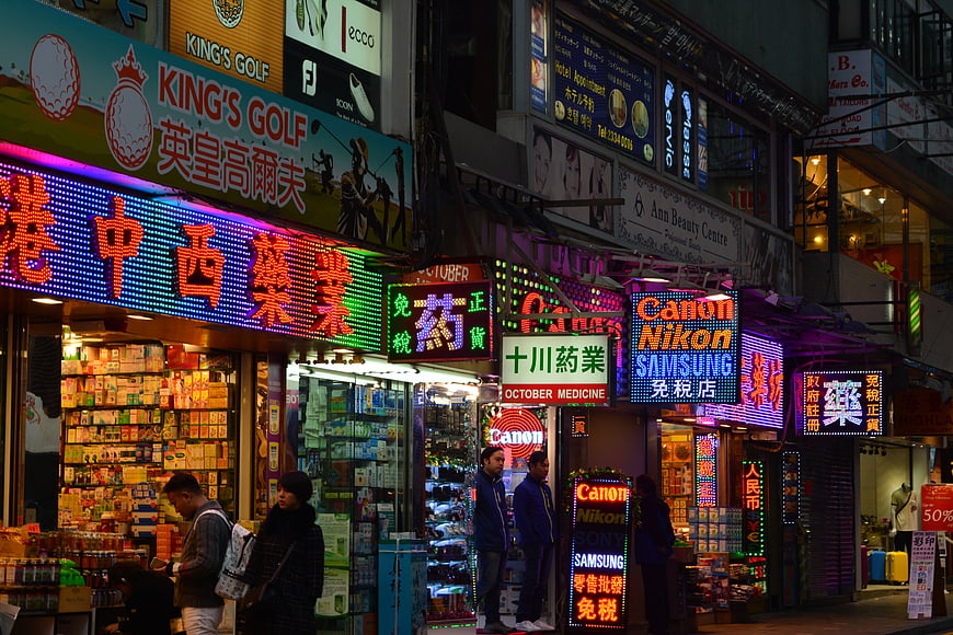 Vibrant Hong Kong street scene with neon signs and shops