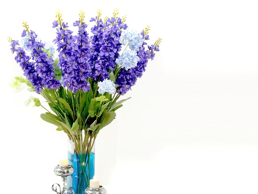 Purple and Blue Flower Bouquet in Blue Vase with Candles
