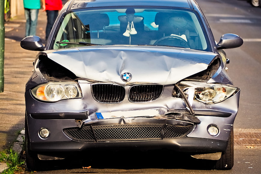 Frontal View of Damaged Silver BMW Car After Collision