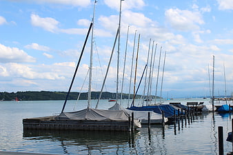 Sailboats docked at a marina on a sunny day