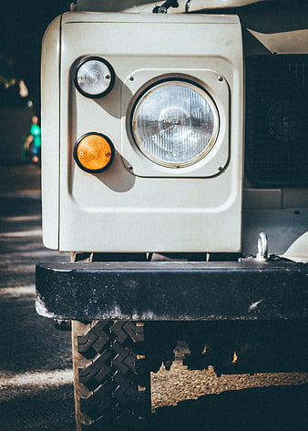 Close-up of vintage off-road vehicle headlight and bumper