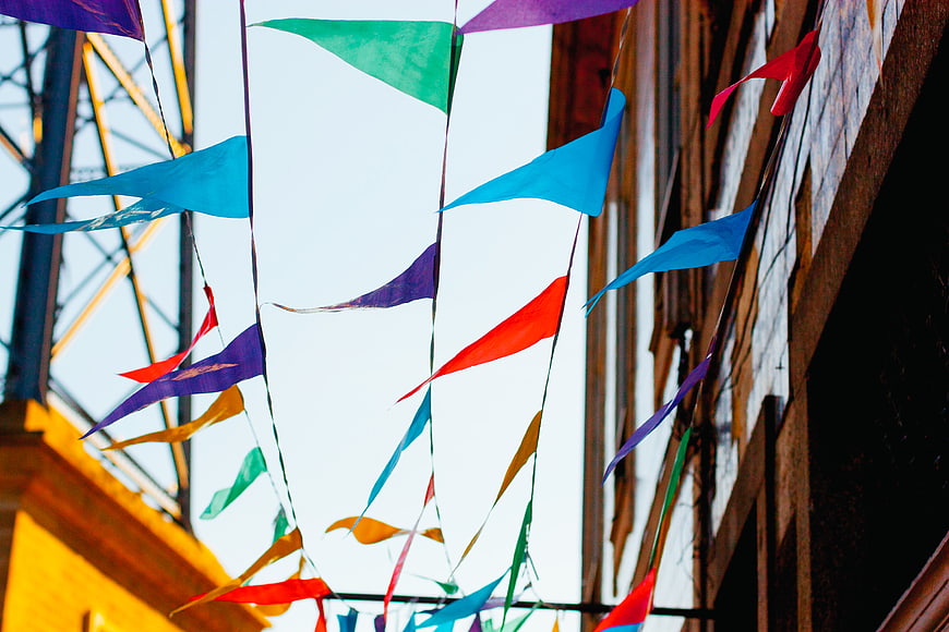 Colorful Festival Pennants Hanging Against Sky