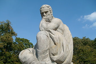 Stone Sculpture of a Thinking Man in Warsaw Park
