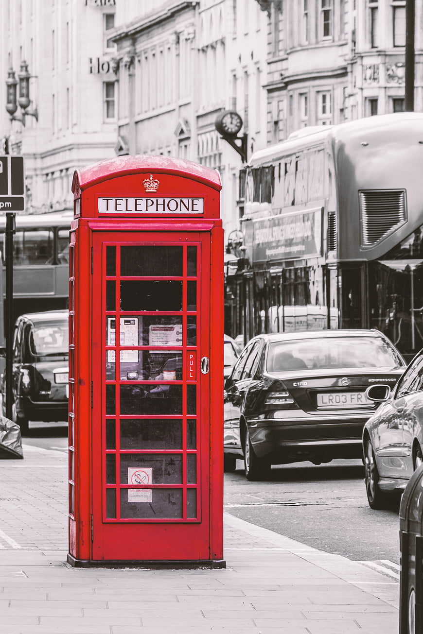Red Telephone Box on London Street with Black and White Background