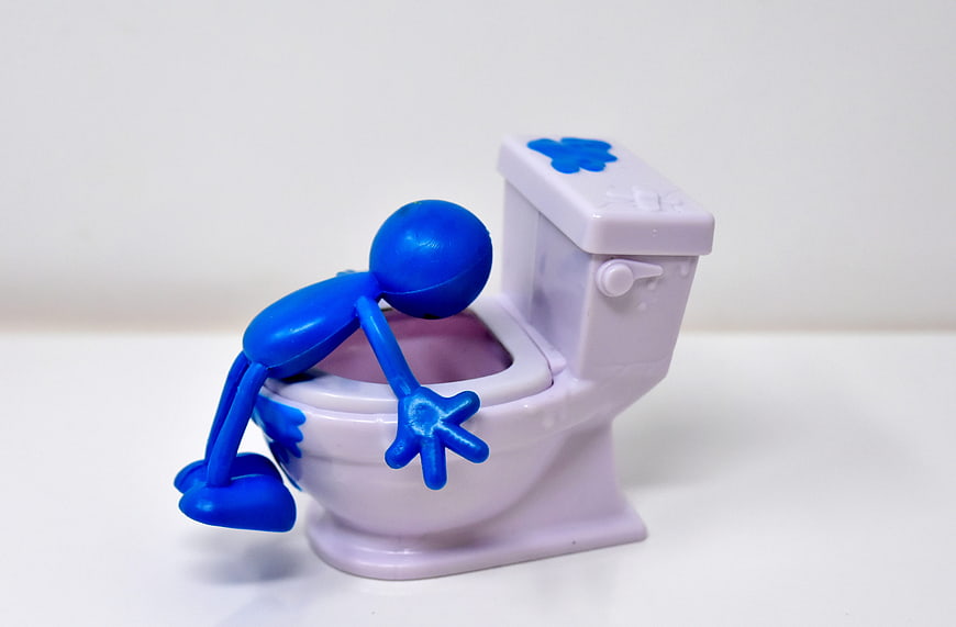 Blue 3D Printed Figure Vomiting into a Miniature Toilet