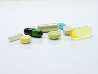 Assorted Vitamins and Supplements on White Background