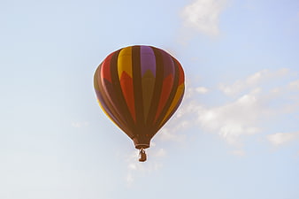Colorful Hot Air Balloon Flying in Blue Sky