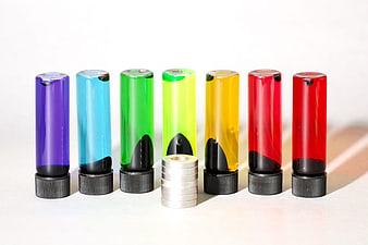 Colorful Ferrofluid Tubes With Magnets On White Background