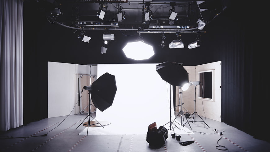 Professional photography studio with lighting equipment and white backdrop