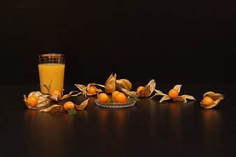 Cape Gooseberries and Juice Still Life on Black Background
