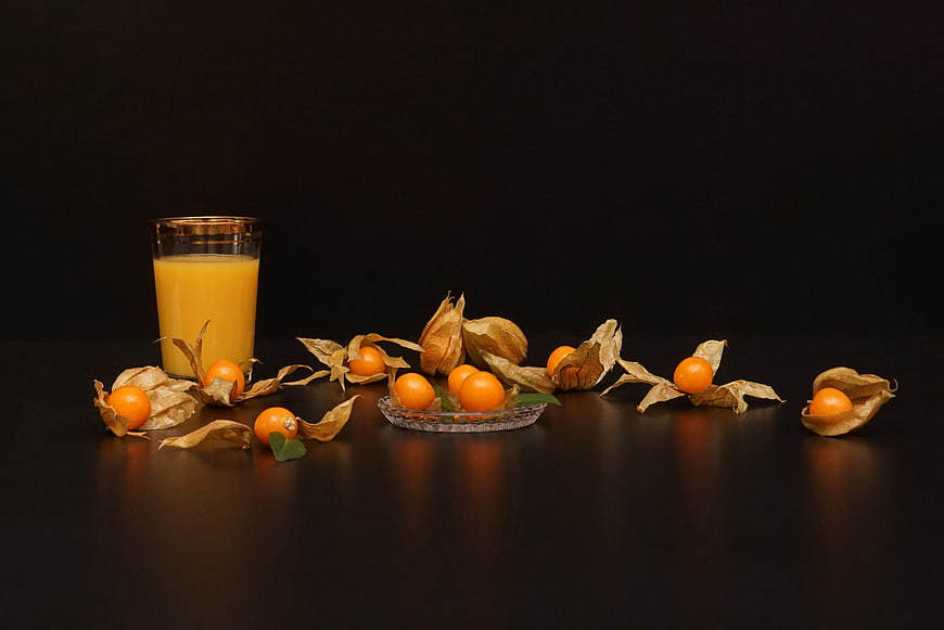 Cape Gooseberries and Juice Still Life on Black Background
