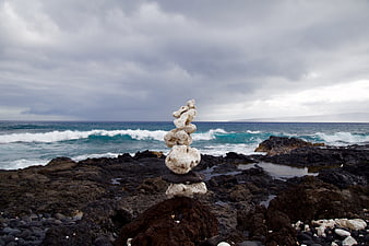 Balanced Rock Stack on Rocky Coastline with Ocean Waves
