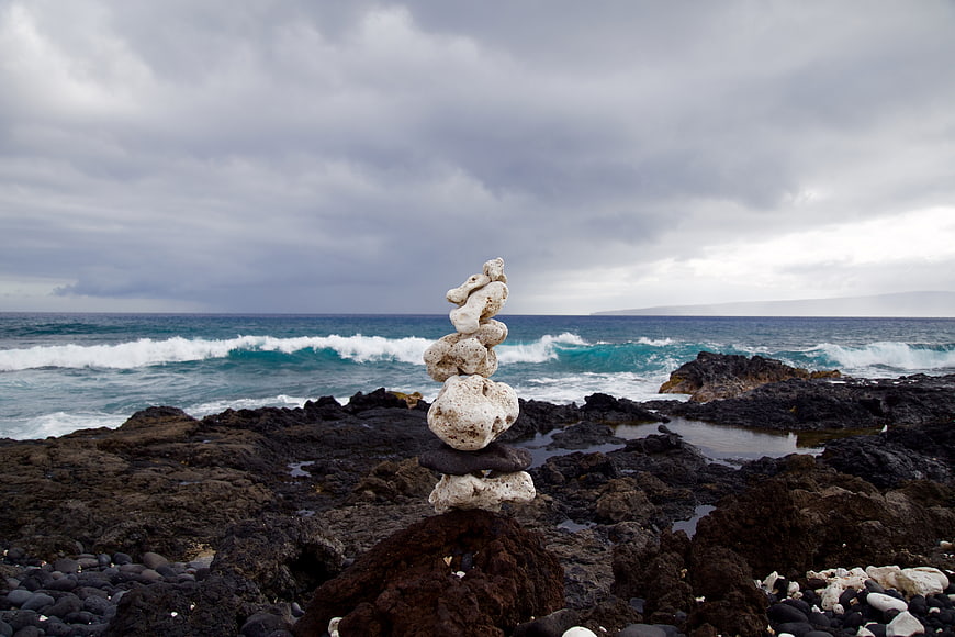 Balanced Rock Stack on Rocky Coastline with Ocean Waves