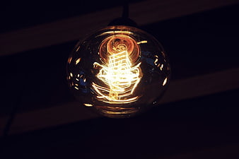 Vintage Edison Light Bulb Glowing in Dark