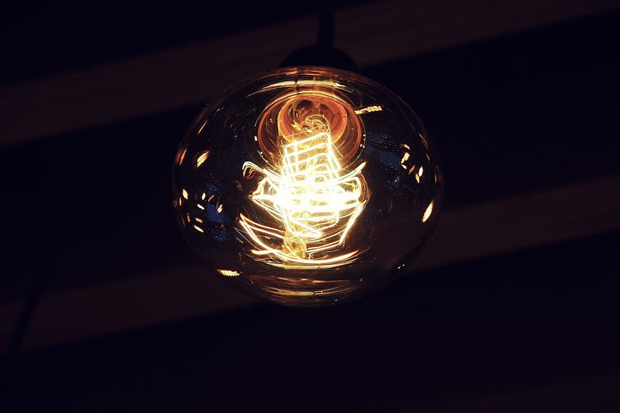 Vintage Edison Light Bulb Glowing in Dark