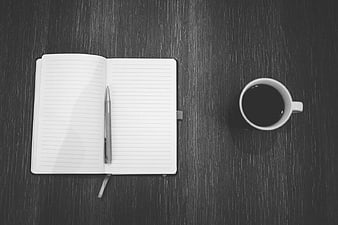Black and White Flat Lay of Notebook and Coffee Cup